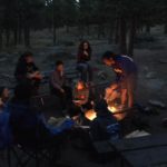 Teens circled around a campfire