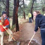 Teens performing trail maintenance