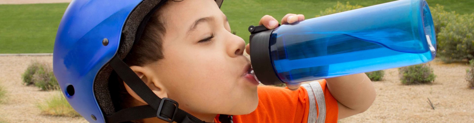 boy drinking from reusable bottle