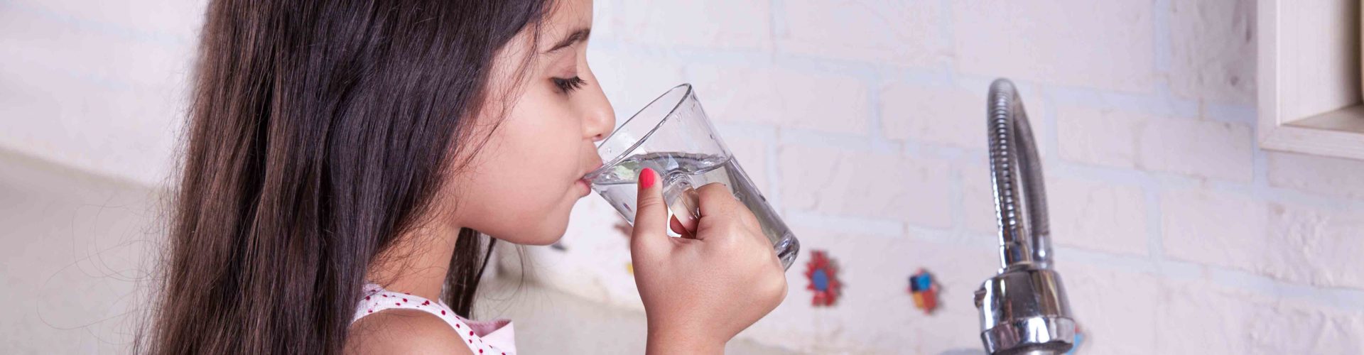 girl drinking a glass of water