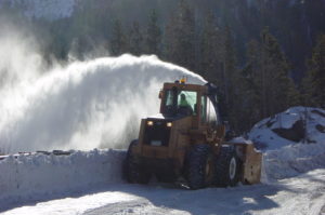 Snow thrower working on county roads