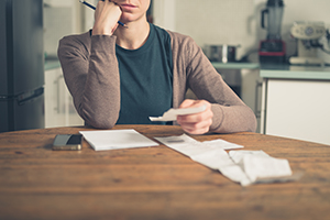 woman worrying about paying her bills