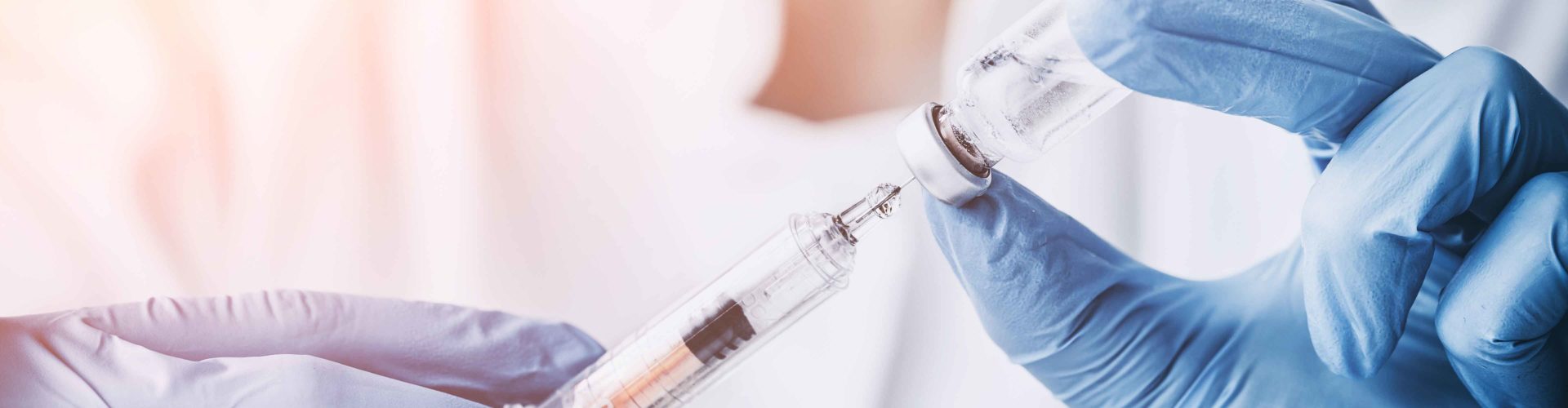 drawing vaccine into syringe