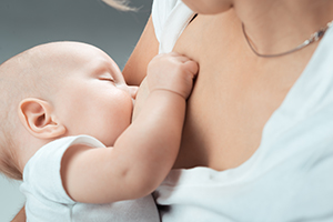 baby breastfeeding with mom
