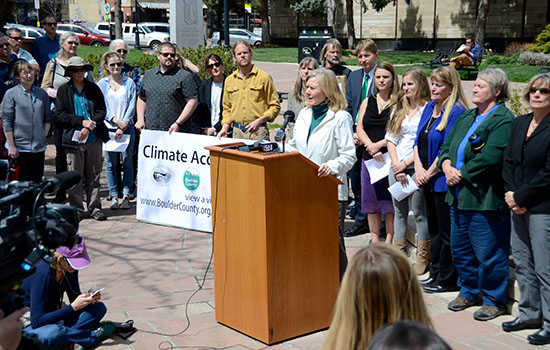 Sierra Club - Indian Peaks Group Chair Rebecca Dickson, at podium, speaks during a Rally for Climate Change Accountability