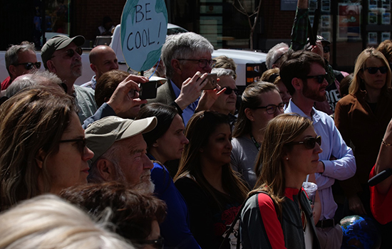 An audience participates in the Climate Accountability Rally