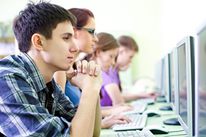 young adults looking at computer screens