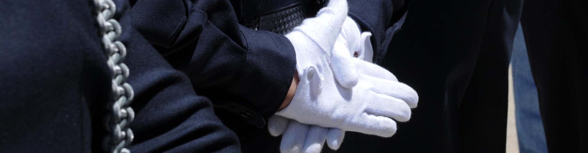Boulder County Sheriff's Office Honor Guard showing respect with hands in white gloves behind their backs