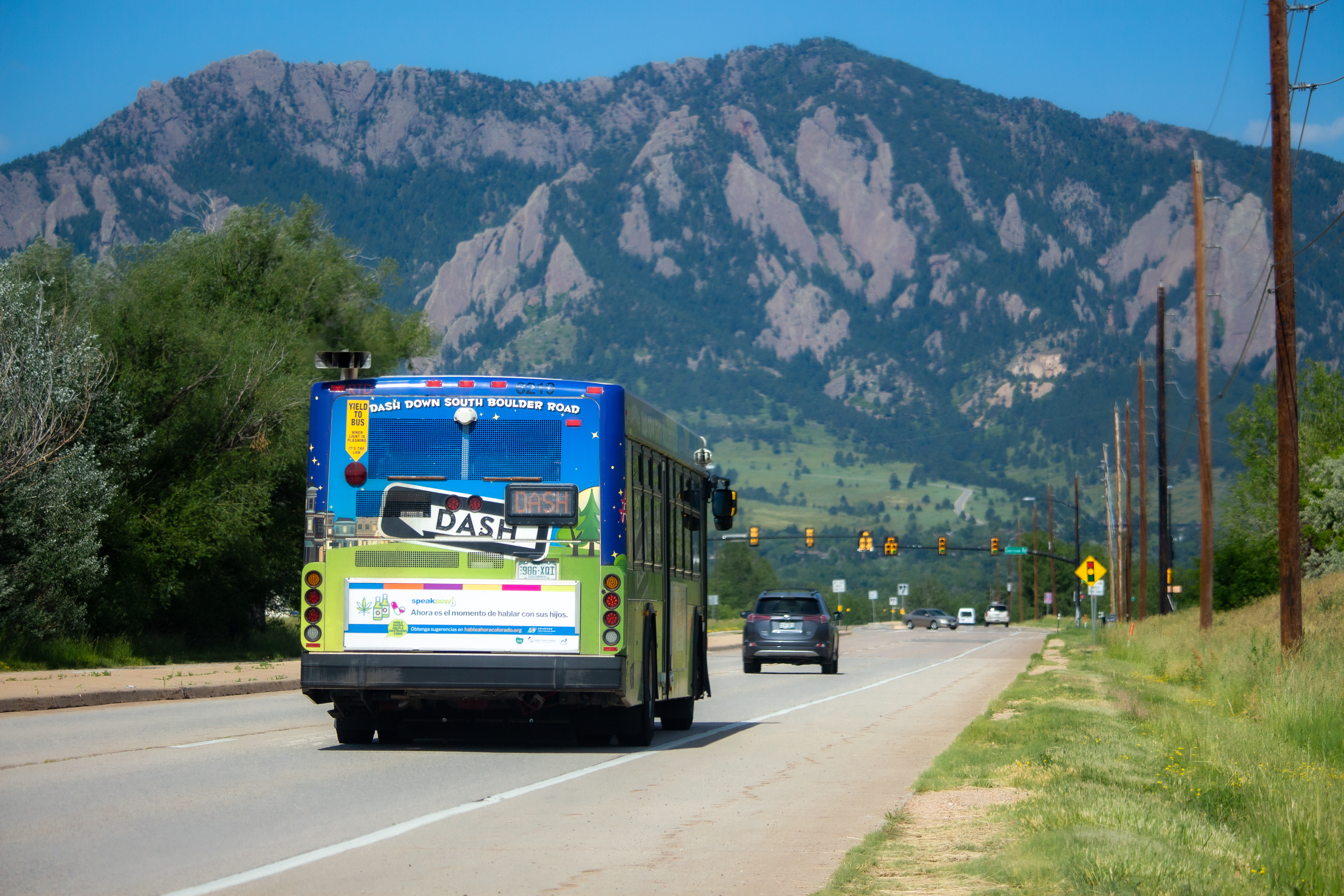 Dash City bus on South Boulder Road with Flatirons in background