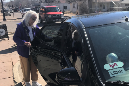 Woman getting into a rideshare vehicle