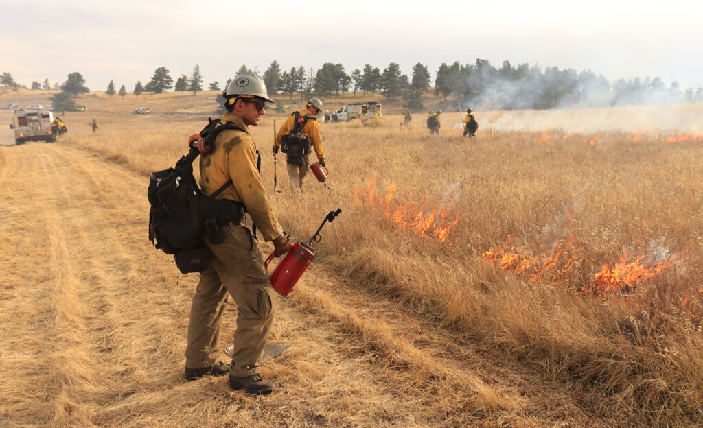 Firefighters monitor a prescribed burn at Hall Ranch Open Space near Lyons in 2021.