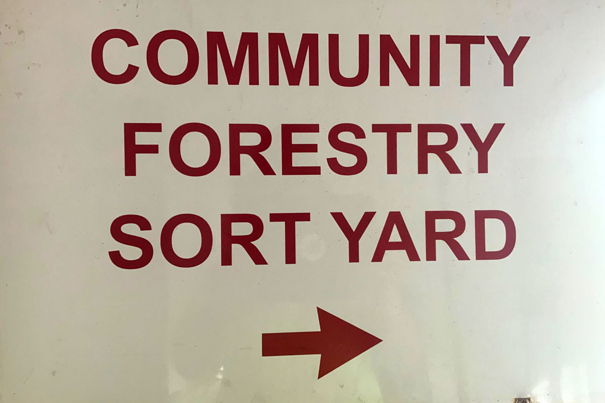 A sign with the text Community Forestry Sort Yard