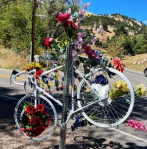 White ghost bike covered in flowers