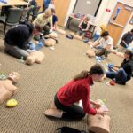 Teens learning CPR