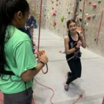 Teen learning how to rock climb