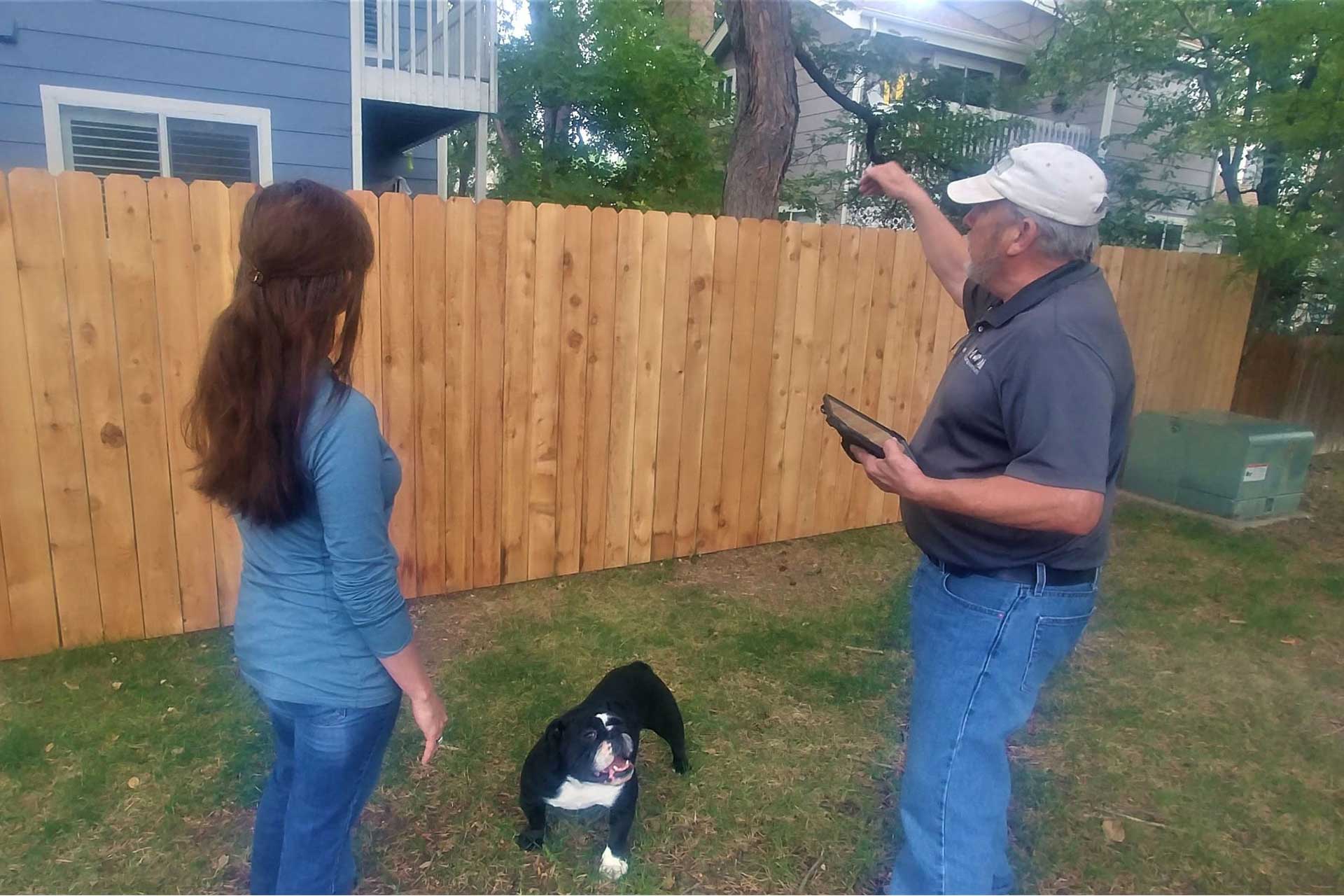 Mitigation specialist speaking with homeowner in yard
