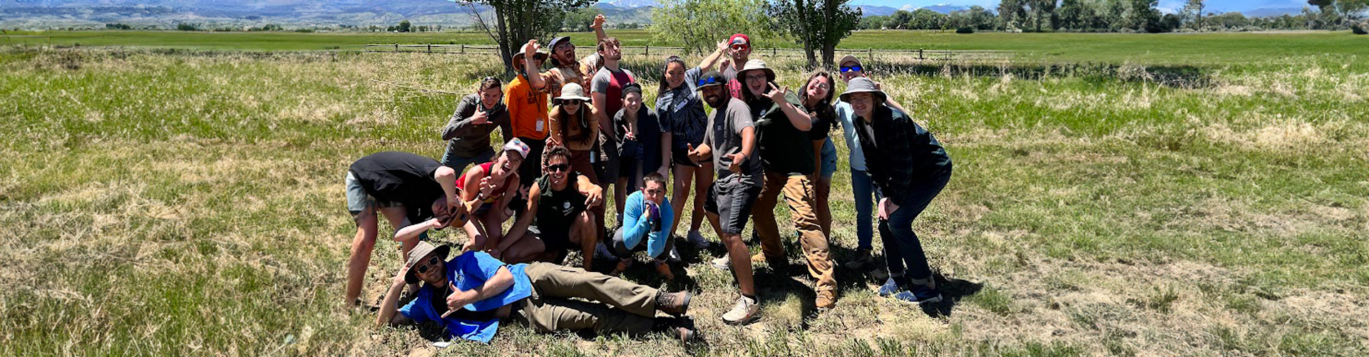 A large group of Youth Corps leaders make silly faces
