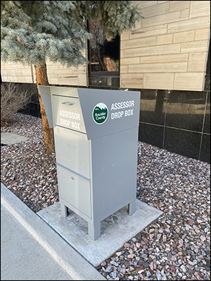 Photo of Assessor's Boulder drop box, 2025 14th St., located near the ATM by the Boulder County parking lot, directly across from the Boulder Theater.