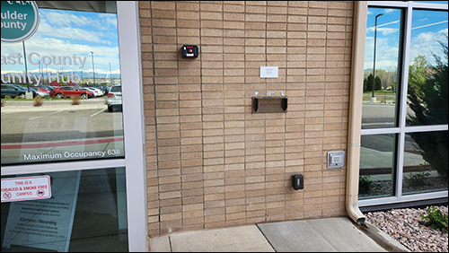 Drop box for documents, forms, and applications. It is a mail slot in the middle of a brick wall on the west side of the Southeast County Community Hub in Lafayette, just to the right of the main entrance on the west side of the building.