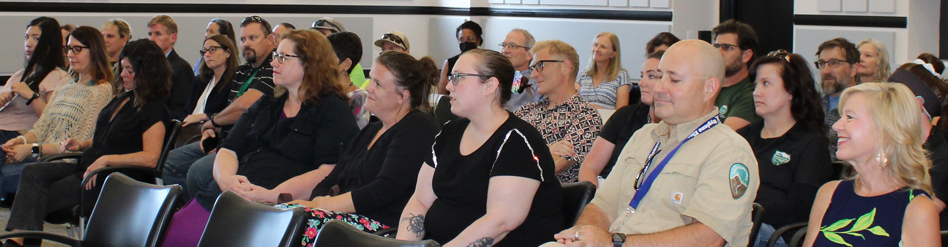 Commissioners' hearing room filled with people facing the front of the room