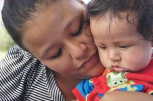 Image of a young Latina mother with her baby