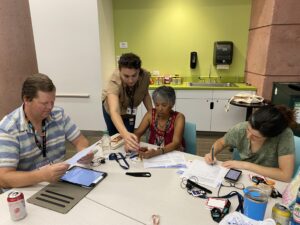 A group of people learning transportation apps at a workshop .