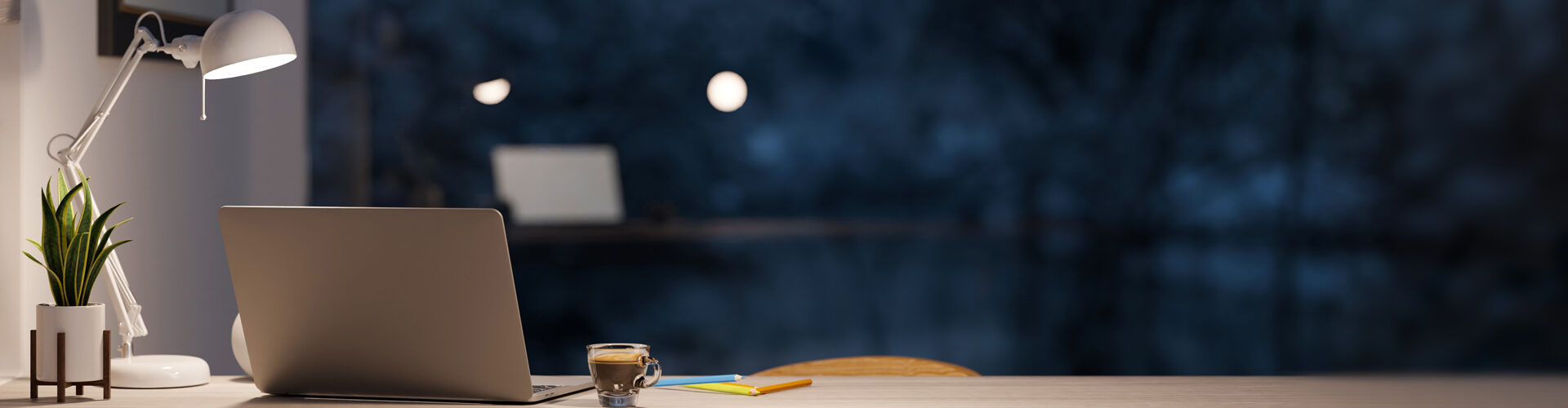 Home office setting at night in front of a window.