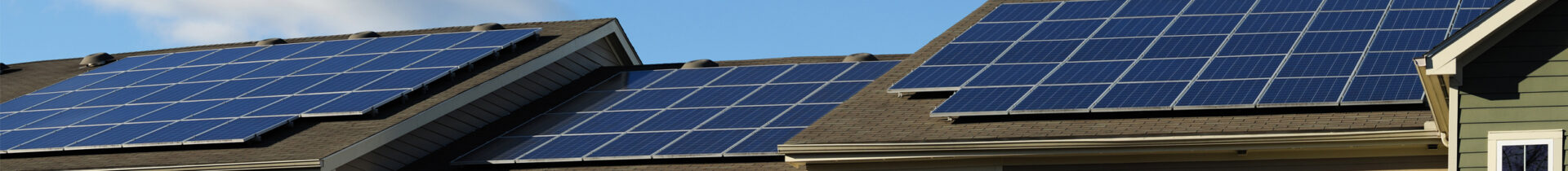 Decorative image of solar panels on roof tops.