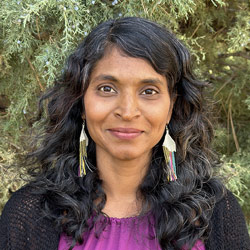 A headshot of a smiling Arpita Kishen