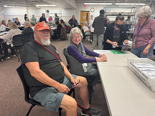 Election Judges work at a table sorting ballots