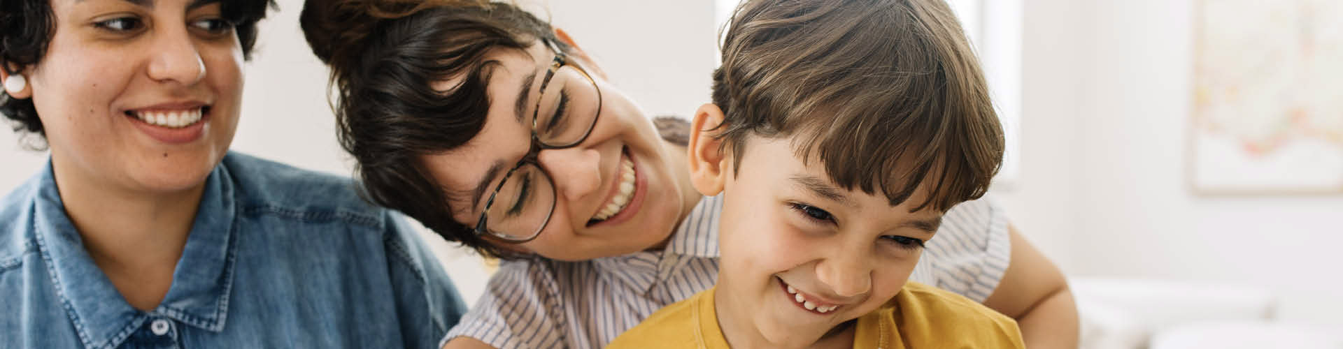 A family of three smiling together