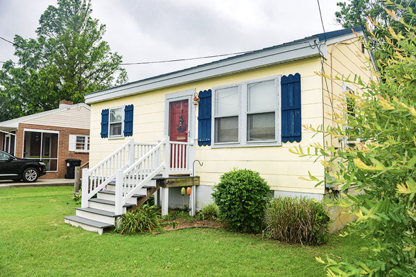 Front entrance of a small yellow house