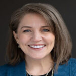 Portrait of Heidi Que smiling in business attire