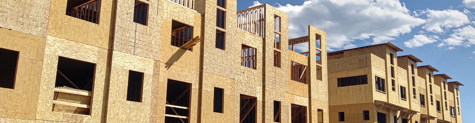 row of apartment buildings being built