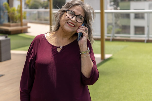 Woman smiling while talking on the phone.