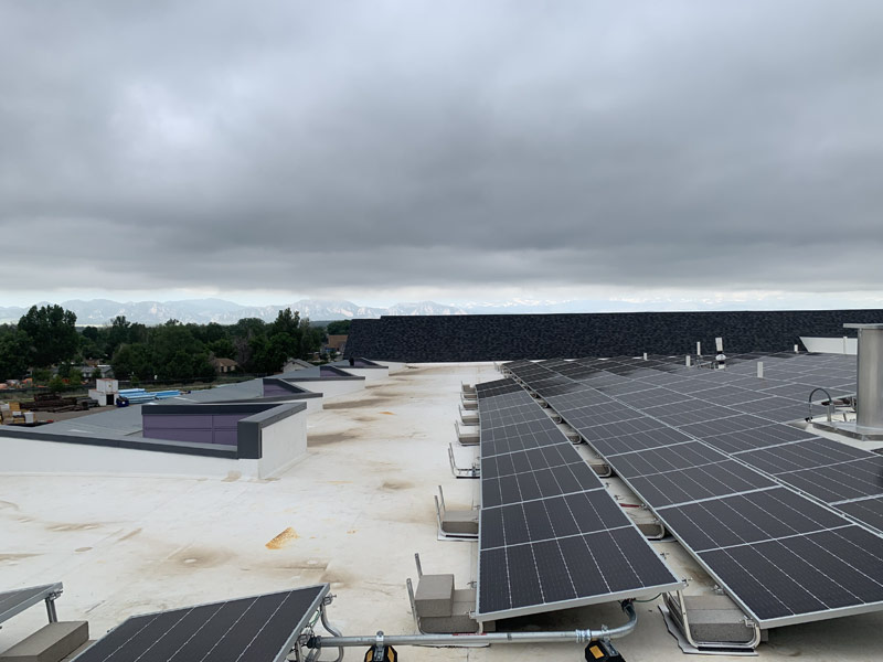 Solar energy arrays on the rooftops of modern, new buildings.