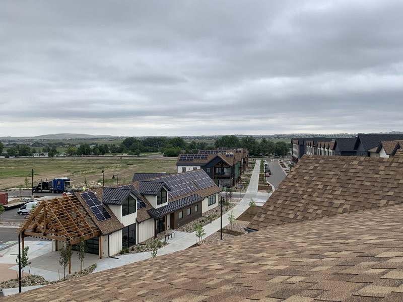 Solar panels installed on the roofs of newly built structures.