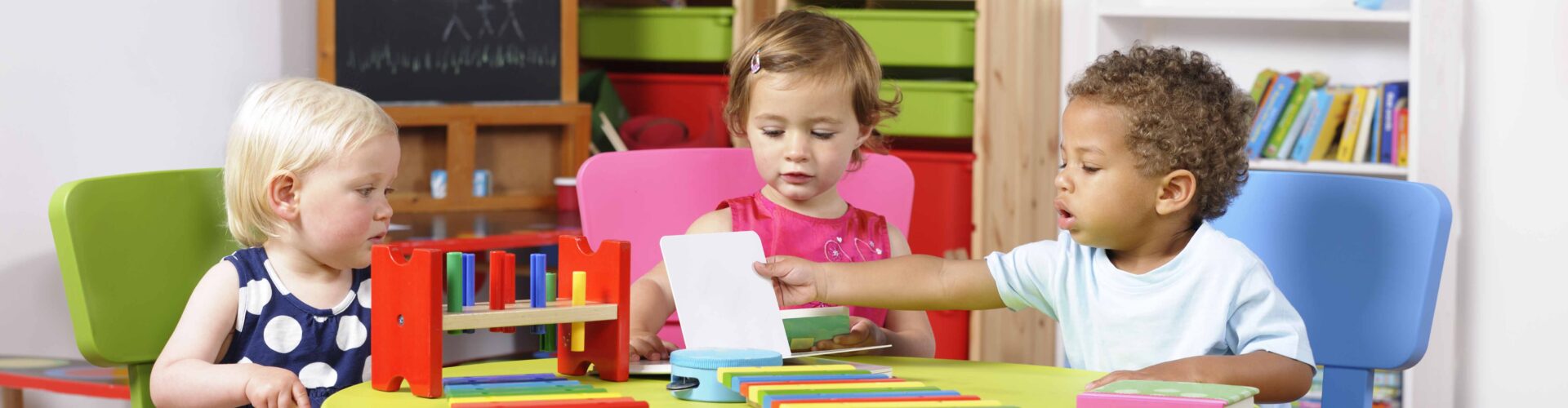 three cute toddlers playing together at child care