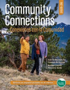 Cover of Boulder County Community Connections 2025-26 magazine. Three people hiking with forest and mountain backdrop.