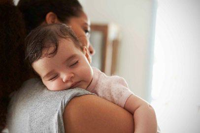 mom holds sleeping baby