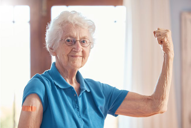 older woman feeling strong after getting her vaccine