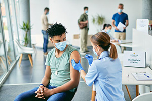 young patient gets a vaccine at a clinic
