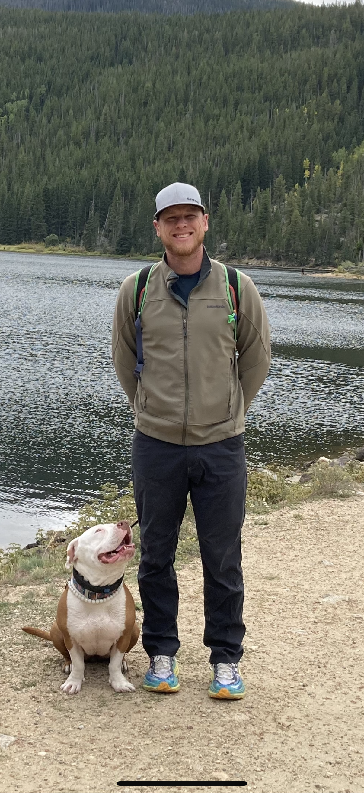 Photo of Tucker Eurman with his dog next to a lake
