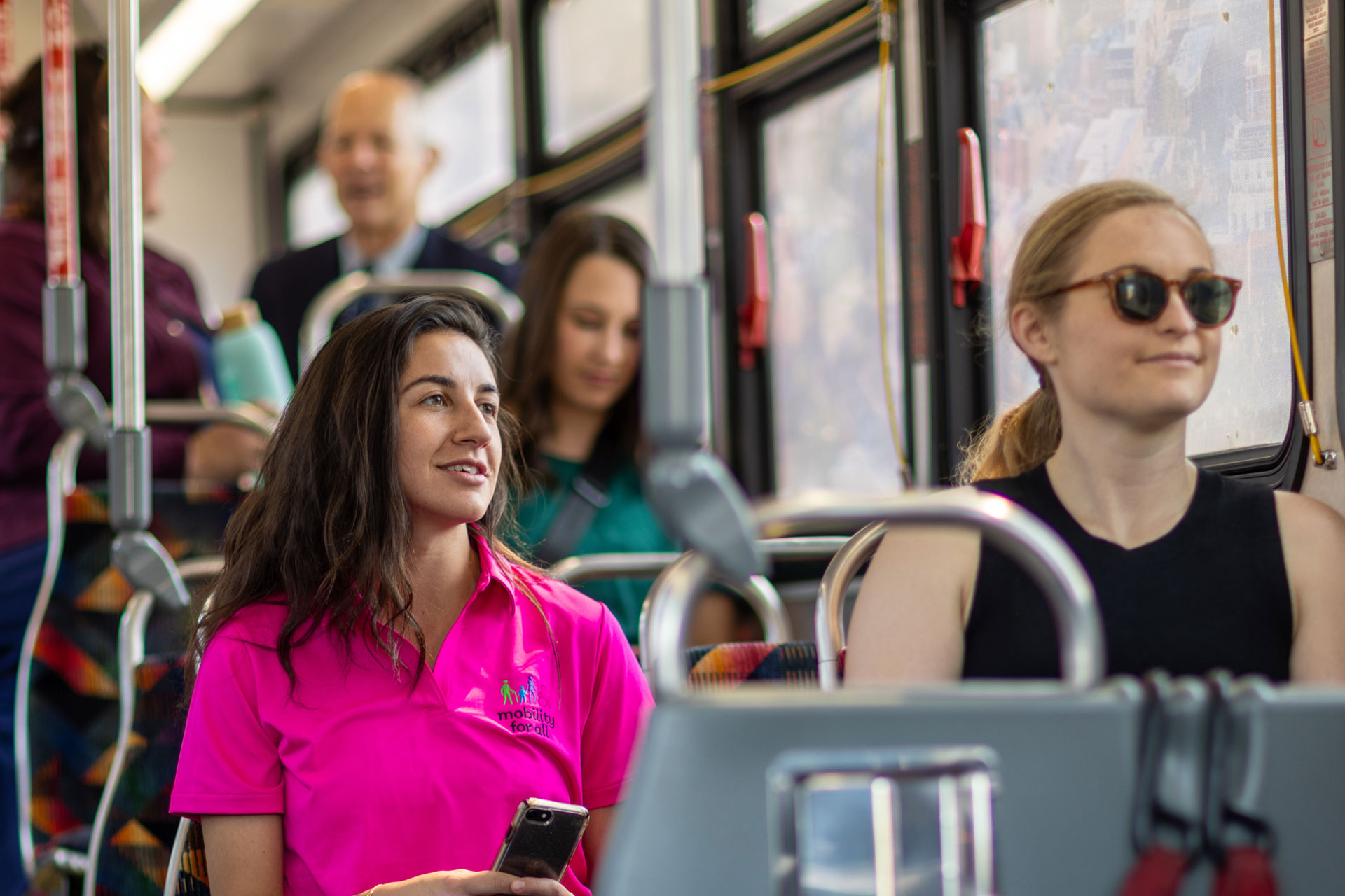 Group of people riding on a city bus.