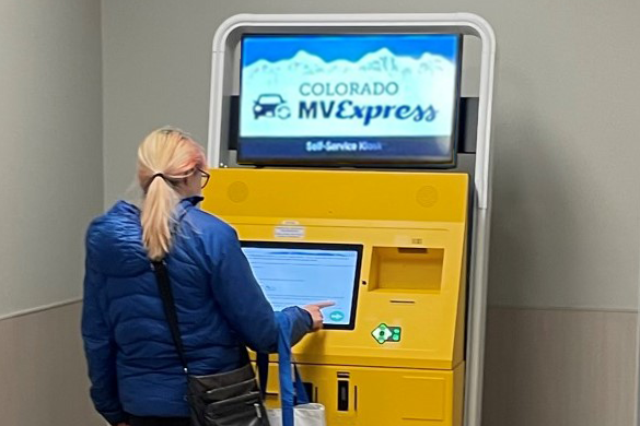 Customer using the motor vehicle express kiosk to renew their vehicle registration