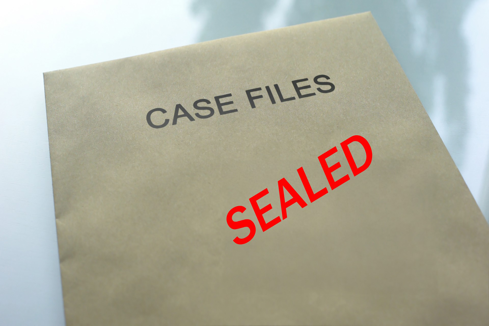 An envelope that has two labels. One is case files and the other in red stated as Sealed.