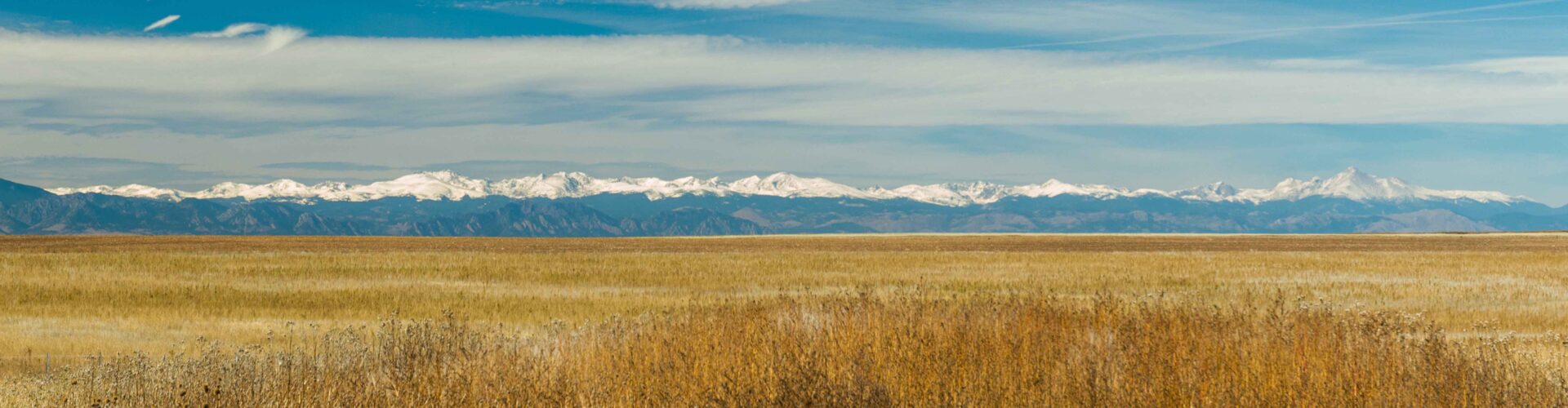 panoramic view of snow topped Front Range mountains