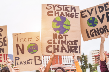 People holding signs asking for action on climate change.