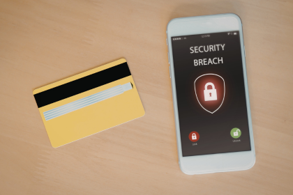 A credit card and a cell phone with the words 