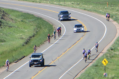 Bicyclists and drivers travel on US 36 north of Boulder.